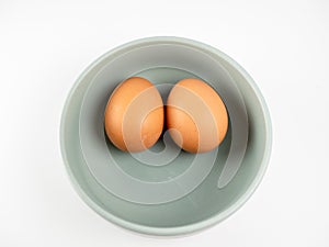 Put eggs in one bowl on white background.