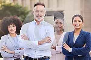 Put my team to the test. a diverse group of businesspeople standing outside on the balcony with their arms folded.