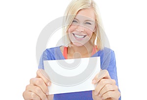 Put your copy right here. A beautiful young woman holding a blank card while isolated on a white background.