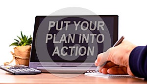 Put your plan into action symbol. Concept words Put your plan into action on the black tablet. Businessman hand with pen. Business