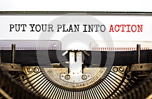 Put your plan into action symbol. Concept words Put your plan into action typed on old retro typewriter. Beautiful white