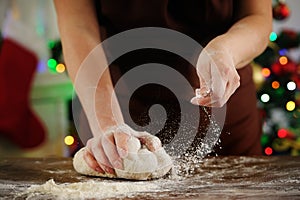 She puts the flour in the dough. Cooking Christmas food.