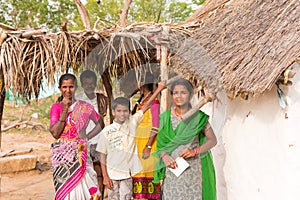 PUTTAPARTHI, ANDHRA PRADESH, INDIA - JULY 9, 2017: Indian family near the house. Copy space for text.