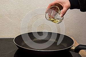 Putting bio oil in the hot black pan