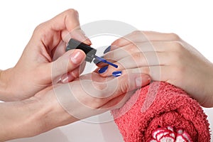 Putting blue nail lacquer photo