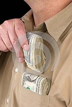 Putting cash in shirt pocket