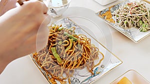 Putting Chinese noodle into the luxury plates and slow motion