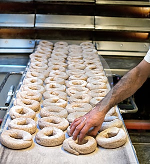 Putting frisella bread into oven