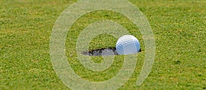 Putting golf ball into hole