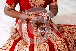 Putting on gracefulness. an unrecognizable bride putting on her bracelets in preparation for her wedding.