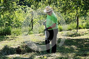 Putting the grass on the trailor. Farm chores, working on a field. photo