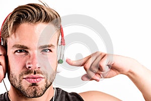 Putting his headset on. ebook and online education. music education. sexy muscular man listen ebook. man in earphones