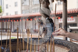 Putting incense into the censer.