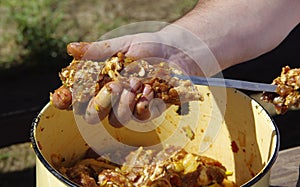 Putting meat on a before cooking