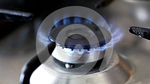 Putting on the natural gas stove with a lighter and putting off. Burning natural gas with blue flames. EU gas crisis.