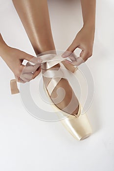 Putting on pointe ballet shoes