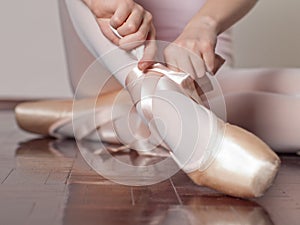 Putting on pointe ballet shoes