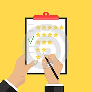 Putting the rating on paper. Hands hold a paper and put a rating of three stars.