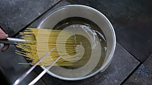 Putting spaghetti into the boiling water