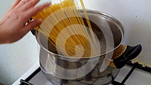 Putting spaghetti into the boiling water side view