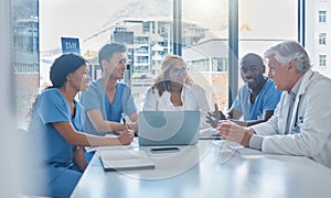 Putting their heads together. a group a medical professionals sitting in the hospital boardroom during a meeting.