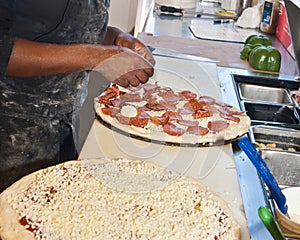 Putting Toppings on Pizza photo