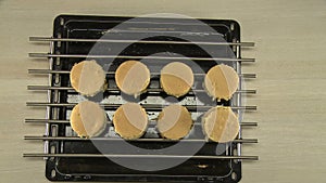 Putting of tray with cake moulds on the table