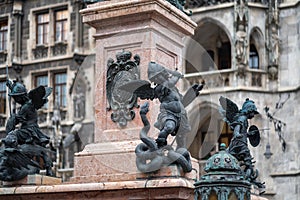 Putto fighting a serpent representing heresy - Mariensaule Sculpture at Marienplatz Square - Munich, Bavaria, Germany