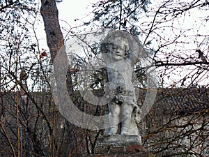 Putto in the garden in a medieval village, Grazzano Visconti, Italy