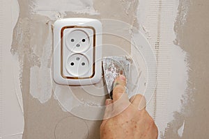 Putty near wall outlet photo