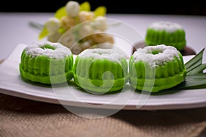 Putu ayu, indonesian traditional food, with plastic flowers as background