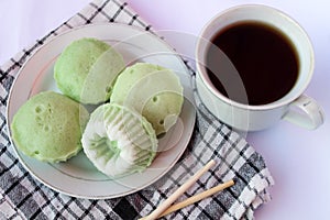 Putu ayu pandan cake, a traditional Indonesian cake made from rice flour and topped with grated coconut.