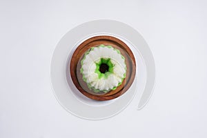 Putu Ayu is served on a wooden plate with white background. photo