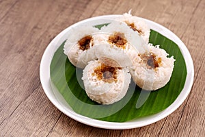 Putu bambu or steamed rice flour cake with grated coconut and palm sugar filling photo