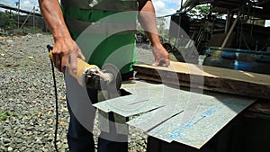 Puyo, Ecuador, 15-4-2019: Person working outdoors with a metal cutting hand saw machine