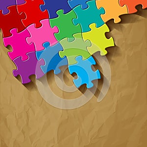 Puzzle colorful on a crumpled paper brown background.