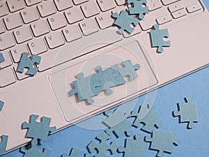 Puzzle elements in a chain of several blocks on a laptop keyboard,