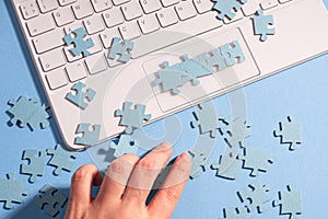 Puzzle elements in a chain of several blocks on a laptop keyboard,