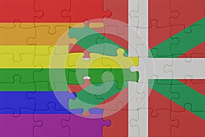 puzzle with the flag of rainbow gay pride and basque country . macro.concept