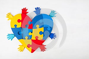 Puzzle heart hands support autism awareness