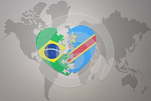 Puzzle heart with the national flag of brazil and democratic republic of the congo on a world map background.Concept photo