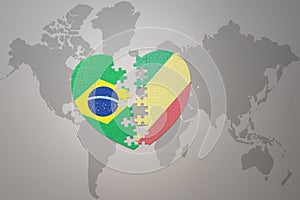 Puzzle heart with the national flag of brazil and republic of the congo on a world map background.Concept photo