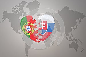 Puzzle heart with the national flag of portugal and slovakia on a world map background.Concept