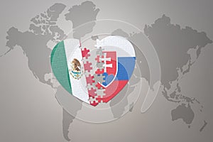 Puzzle heart with the national flag of slovakia and mexico on a world map background.Concept