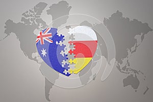 Puzzle heart with the national flag of south ossetia and australia on a world map background. Concept