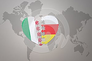 Puzzle heart with the national flag of south ossetia and italy on a world map background. Concept