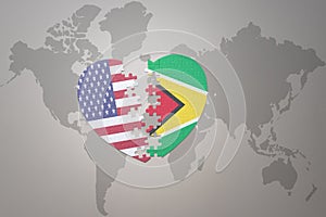 Puzzle heart with the national flag of united states of america and guyana on a world map background. Concept