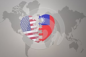 Puzzle heart with the national flag of united states of america and taiwan on a world map background. Concept