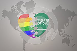 Puzzle heart with the rainbow gay flag and saudi arabia on a world map background. Concept