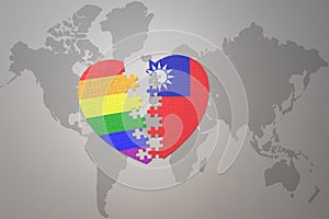 Puzzle heart with the rainbow gay flag and taiwan on a world map background. Concept